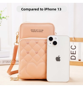 Pink heart quilted phone bag size comparison with iPhone 13 for scale reference