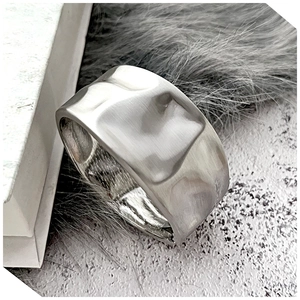 Detail of silver hammered texture cuff bracelet showing minimalist irregular metal finish