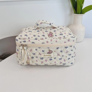 Quilted beige cosmetic bag with floral and teddy bear print and sturdy top handle