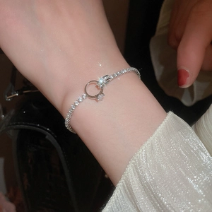 Close-up of a sparkling zircon knotted bracelet with an interlocking ring design
