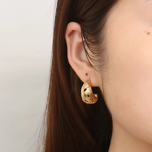 Women's 18K gold plated mesh texture C-shaped hoop earrings worn by a model