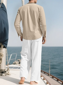 Close-up of beige linen shirt texture and white pants on a model at sea