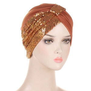 Close-up of brown turban hat featuring gold sequin patchwork and elastic fabric