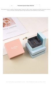 Detail of premium textured paper jewelry boxes in pink and blue with grey velvet interior