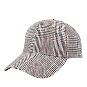 Detail of red and grey plaid baseball cap showing wool blend fabric texture and curved brim