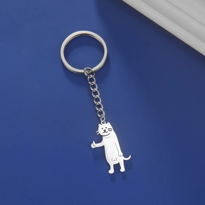 Detailed view of cartoon cat stainless steel keychain with thumbs-up pose on blue background