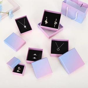 Macro view of purple and blue gradient jewelry gift boxes with matching paper handle bags