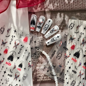 Gothic nail art stickers with butterfly, skull, and castle motifs in dark aesthetic