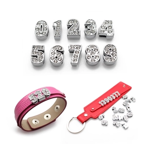 Close-up of rhinestone number sliders on leather bracelets for DIY jewelry making