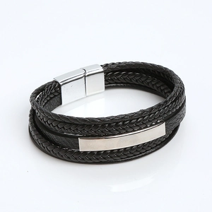 Detail of multi-layer black braided leather bracelet with silver magnetic metal clasp