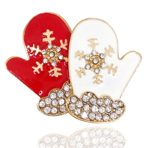 Detailed view of enamel Christmas glove brooch with snowflakes and sparkling rhinestones