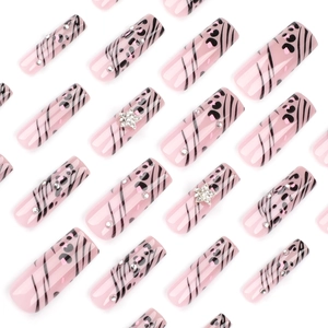 Pink leopard press on nails with zebra patterns, silver stars, and sparkling rhinestones