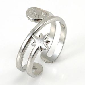 Macro shot of silver double-layered open ring with star and radiant disc charms