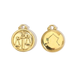 Detail of 14K gold plated Libra zodiac pendant showing embossed scales and starry back