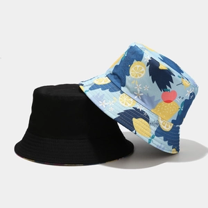 Double-sided sun hat featuring black base and blue lemon print pattern with canvas texture