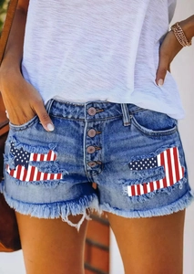 Detailed shot of frayed denim shorts featuring patriotic American flag patch and metal buttons