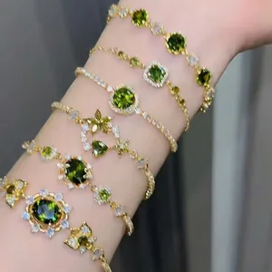 Set of six vintage 18k gold plated bracelets with green zircon and floral charms