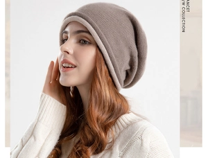 Close-up of khaki slouchy beanie with beige rolled edge and fine knitted texture