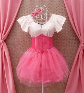 Detail of a pink and white Lolita dress with lace-up corset and tiered tulle skirt