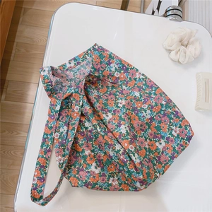 Detailed flat lay of floral canvas bag with vintage orange and blue flower patterns