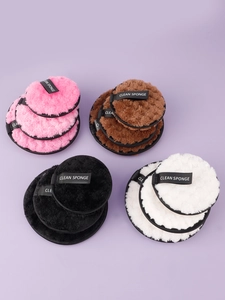 Close-up of four-color microfiber makeup sponges with soft long hair and grab straps