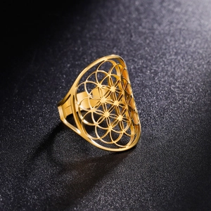 Golden hollow flower pattern ring with geometric cutout design on a black background
