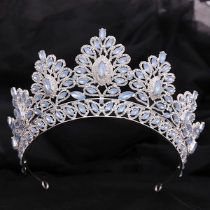 Macro shot of silver bridal crown featuring light blue opal leaves and sparkling rhinestones
