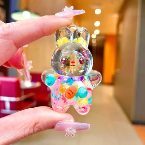 Close-up of rabbit drifting bottle keychain with colorful beads and carrot charms