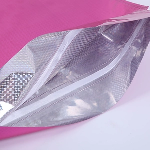 Detail of rose pink drawstring gift bag with silver holographic lining and white closure