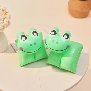 Close-up of inflatable green frog arm floats on a wooden table for kids swimming aid
