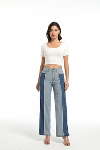 Women's low-waisted jeans featuring contrast color patchwork and raw hem edge detail