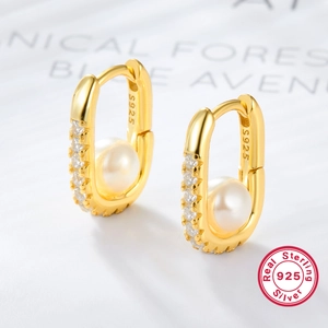 S925 sterling silver hoop earrings with square pearls and zircons on a magazine background