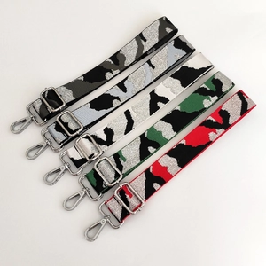 Close-up of five adjustable camouflage pattern replacement straps with silver lobster clasps