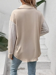 Detail of elegant beige shirt with crochet lace stitching and woven texture on sleeves