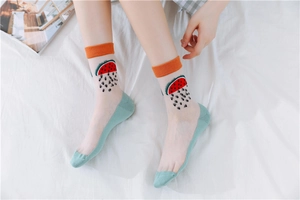 Close-up of sheer mesh socks with watermelon pattern and orange ribbed cuffs