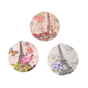 Three vintage Eiffel Tower folding makeup mirrors with floral and post card patterns