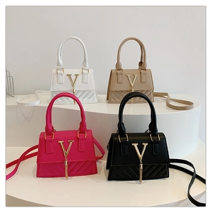 Quilted handbags with V-shaped metal logo and tassel charms in four stylish colors