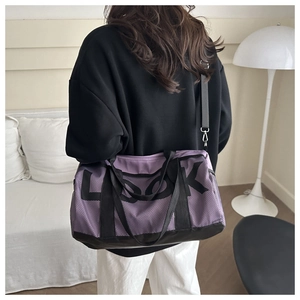 Detail view of purple fitness yoga bag with LOOK print and mesh design on model's back
