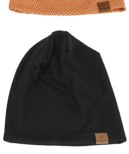 Detail of knitted beanie hats in black and orange checkered pattern with leather brand labels