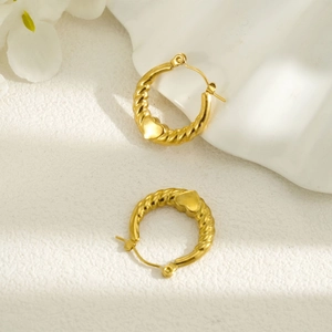 Detailed close-up of 18k gold-plated stainless steel twisted heart hoop earrings for women