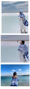 Detail of blue and white ethnic pattern shawl draped elegantly at a seaside beach location