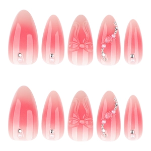 Pink gradient press-on nails with 3D bows, pearls and heart sequins on almond shape