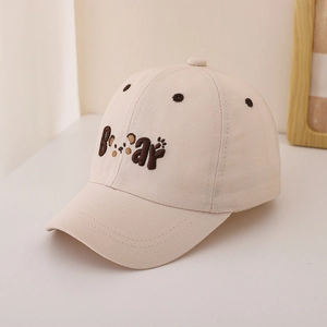 Detailed close-up of beige cotton baseball cap featuring embroidered brown Bear text