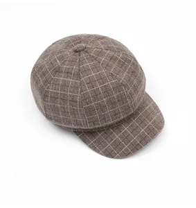 Top down view of brown plaid newsboy cap showing wool texture and pattern details