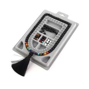 Detailed view of grey bead design board featuring measurement scale slots for DIY jewelry crafting.