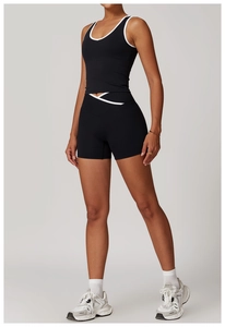 Detail view of black sports top with white trim and matching V-waist fitness shorts