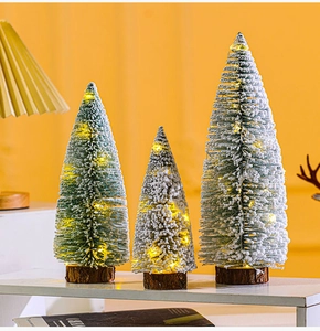 Three-piece frosted mini Christmas trees with warm LED lights on solid wood bases
