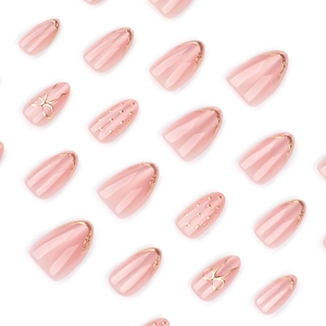 Faux ongles amande œil-de-chat rose avec nœuds dorés 3D et pointes françaises