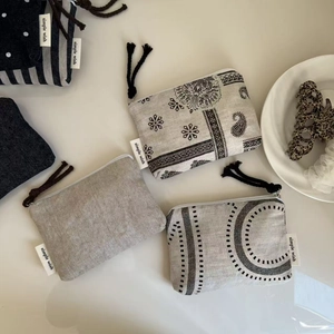 Flat lay of vintage denim canvas pouches with zipper closures and various patterns