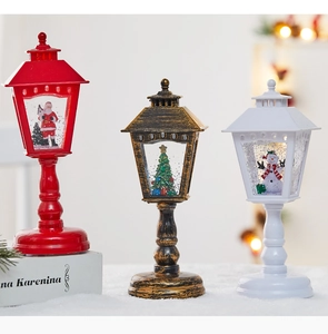 Close-up of three festive Christmas water lanterns with Santa, tree and snowman figurines